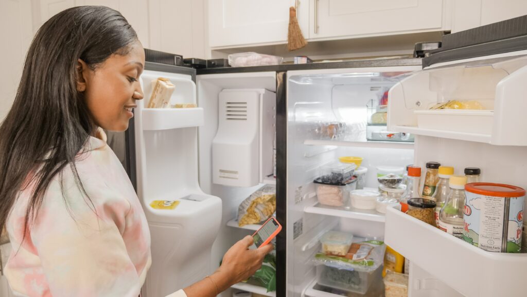 woman checking fridge
