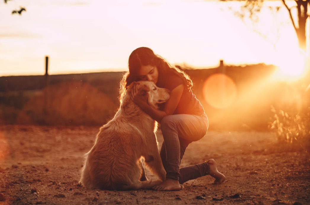 woman hugging a pet dog